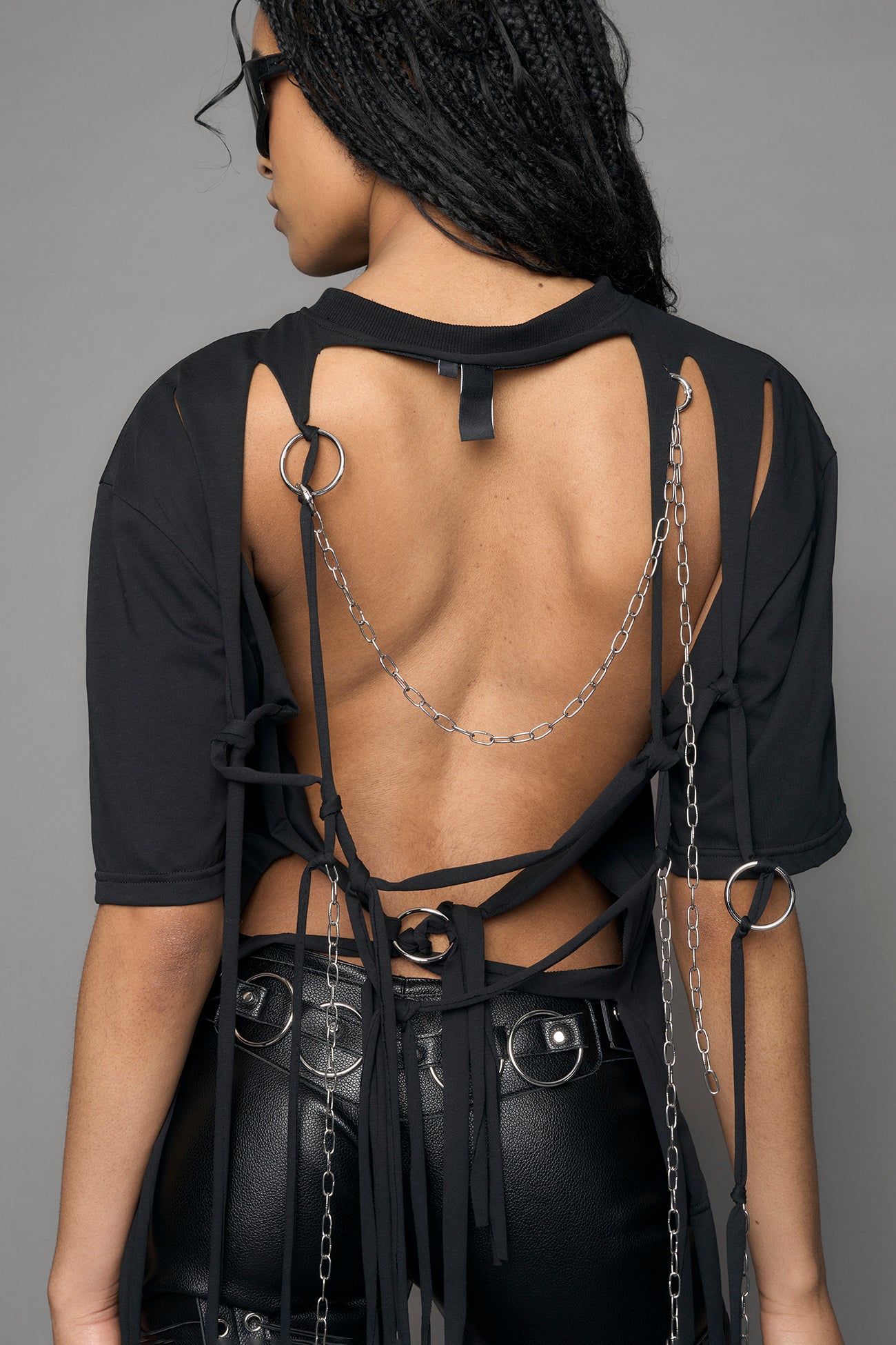 deconstructed open back design feat. metal rings and chains